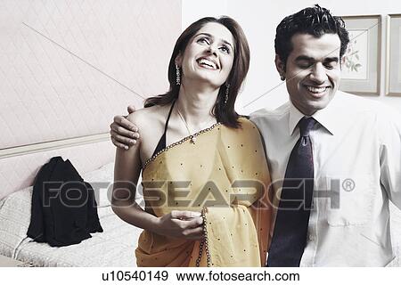 Close-up of a young couple smiling View Large Photo Image Stock Photo - Close-up of a young couple smiling. Fotosearch