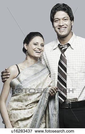 Close-up of a young couple smiling View Large Photo Image Stock Photo - Close-up of a young couple smiling. Fotosearch
