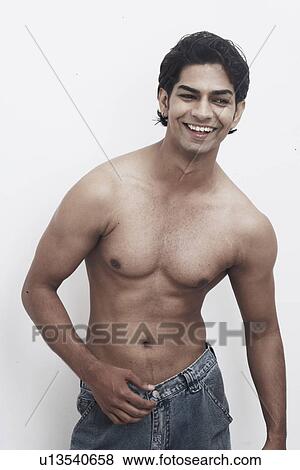 Close-up of a young man smiling View Large Photo Image Stock Photo - Close-up of a young man smiling. Fotosearch