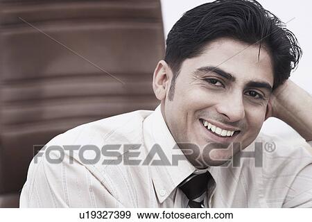 Portrait of a businessman smiling View Large Photo Image Stock Photo - Portrait of a businessman smiling. Fotosearch