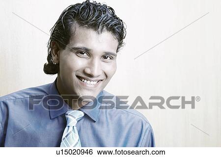 Stock Photograph - Portrait of a businessman smiling. Fotosearch