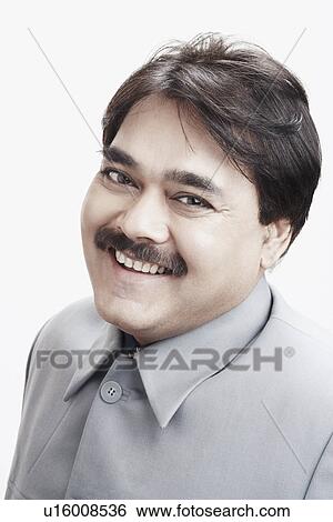 Stock Photograph - Portrait of a businessman smiling. Fotosearch