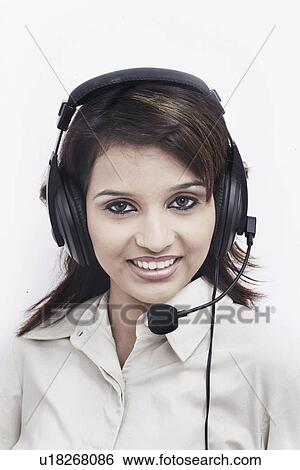 Portrait of a businesswoman wearing a headset smiling View Large Photo Image Stock Photograph - Portrait of a businesswoman wearing a headset smiling. Fotosearch