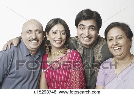 Stock Photograph - Portrait of a mature couple and a mid adult couple smiling. Fotosearch