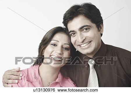 Stock Photograph - Portrait of a mid adult couple smiling. Fotosearch