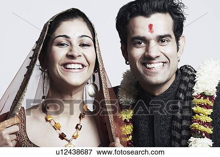 Portrait of a newlywed couple smiling View Large Photo Image Stock Photo - Portrait of a newlywed couple smiling. Fotosearch
