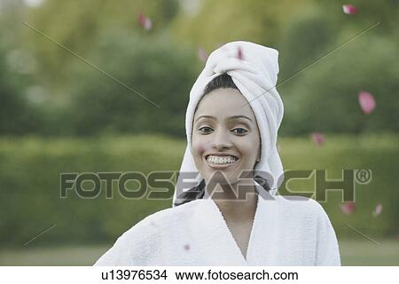 Portrait of a teenage girl smiling with a towel wrapped around her head View Large Photo Image Picture - Portrait of a teenage girl smiling with a towel wrapped around her head. Fotosearch