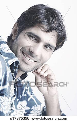 Stock Photograph - Portrait of a young man smiling. Fotosearch