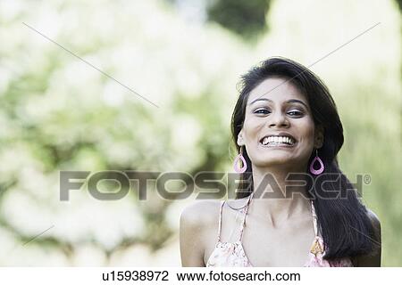 Stock Image - Portrait of a young woman smiling. Fotosearch