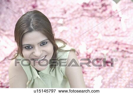 Portrait of a young woman smiling View Large Photo Image Stock Photo - Portrait of a young woman smiling. Fotosearch