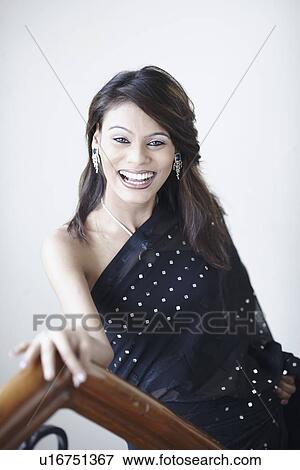 Portrait of a young woman smiling View Large Photo Image Stock Photo - Portrait of a young woman smiling. Fotosearch