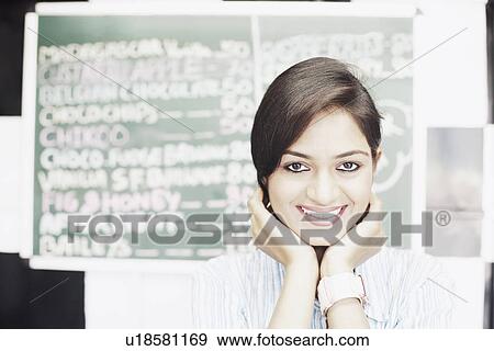 Portrait of a young woman smiling View Large Photo Image Stock Photo - Portrait of a young woman smiling. Fotosearch