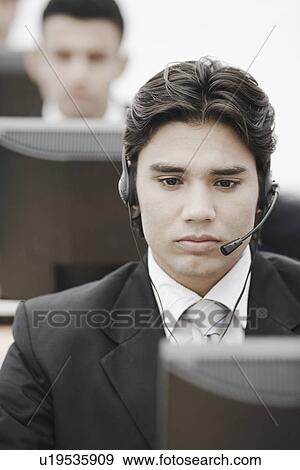 Stock Photo - Close-up of a businessman wearing a headset. Fotosearch