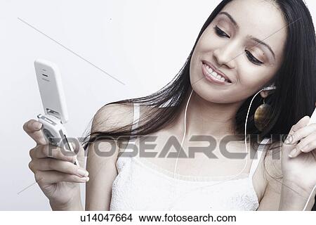 Close-up of a teenage girl holding a mobile phone View Large Photo Image Picture - Close-up of a teenage girl holding a mobile phone. Fotosearch