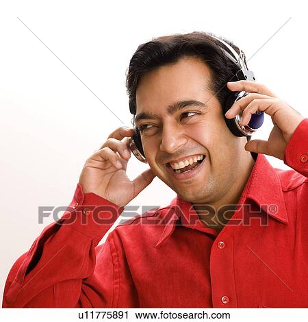 Stock Image - Close-up of a young man wearing headphones. Fotosearch