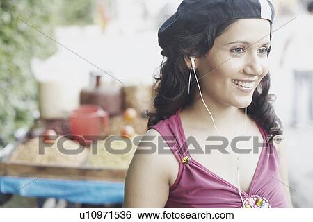 Close-up of a young woman wearing a headset View Large Photo Image Stock Photograph - Close-up of a young woman wearing a headset. Fotosearch