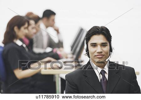 Stock Image - Portrait of a businessman wearing a headset. Fotosearch