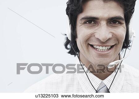 Portrait of a businessman wearing a headset View Large Photo Image Stock Image - Portrait of a businessman wearing a headset. Fotosearch