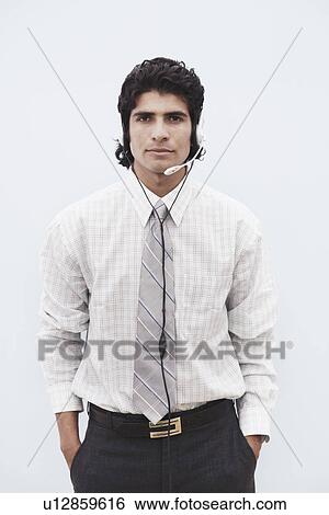 Stock Photograph - Portrait of a businessman wearing a headset. Fotosearch