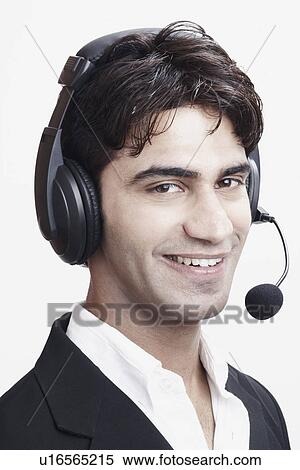 Stock Photography - Portrait of a young man wearing a headset. Fotosearch