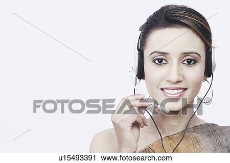Portrait of a young woman wearing a headset View Large Photo Image Stock Image - Portrait of a young woman wearing a headset. Fotosearch