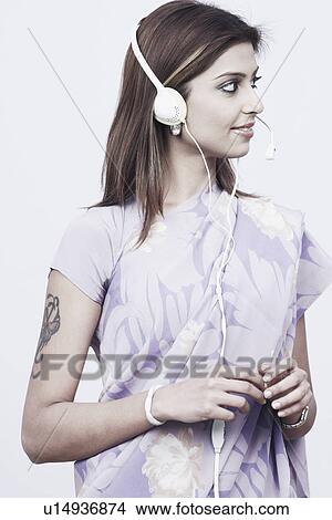 Young woman wearing a headset View Large Photo Image Picture - Young woman wearing a headset. Fotosearch