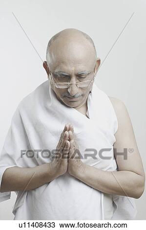 Stock Image - Close-up of a mature man in a prayer position. Fotosearch