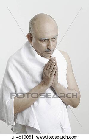 Stock Image - Close-up of a mature man in a prayer position. Fotosearch