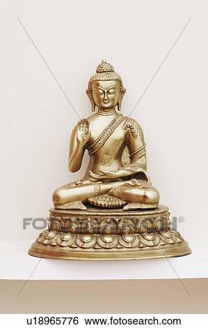 Stock Photograph - Close-up of a statue of Buddha. Fotosearch