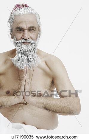 Stock Photography - Portrait of a priest sitting in a prayer position. Fotosearch