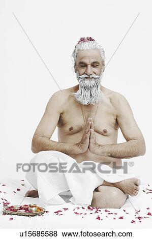 Priest in a prayer position with his eyes closed View Large Photo Image Stock Photo - Priest in a prayer position with his eyes closed. Fotosearch
