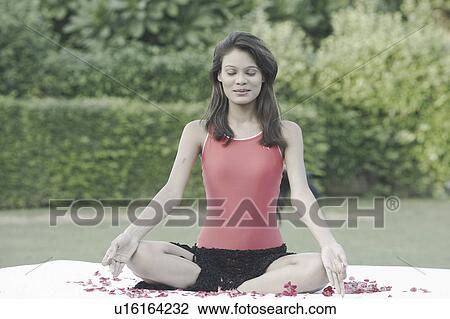 Young woman meditating with her eyes closed View Large Photo Image Stock Image - Young woman meditating with her eyes closed . Fotosearch