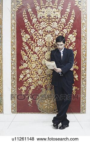 Stock Photo - Businessman reading a newspaper. Fotosearch