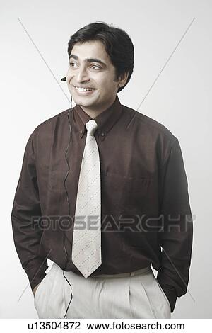 Stock Image - Businessman using a hands free device. Fotosearch