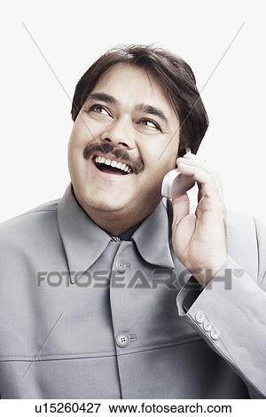 Stock Photo - Close-up of a businessman talking on a mobile phone. Fotosearch
