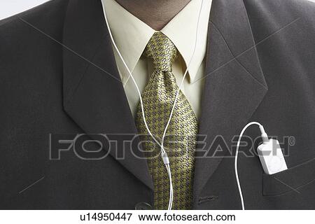 Mid section view of a businessman with an mp3 player in his pocket View Large Photo Image Stock Photo - Mid section view of a businessman with an mp3 player in his pocket. Fotosearch