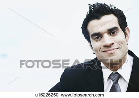 Stock Image - Portrait of a businessman smiling. Fotosearch