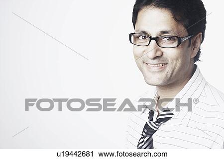 Portrait of a businessman smiling View Large Photo Image Stock Image - Portrait of a businessman smiling. Fotosearch
