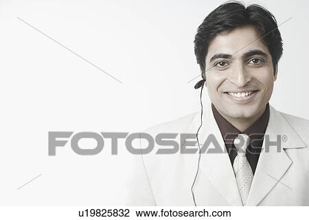 Portrait of a businessman using a hands free device View Large Photo Image Stock Image - Portrait of a businessman using a hands free device. Fotosearch
