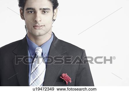 Stock Photo - Portrait of a young man wearing a suit. Fotosearch