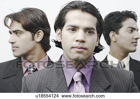 Close-up of a businessman in front of two businessmen View Large Photo Image Picture - Close-up of a businessman in front of two businessmen. Fotosearch