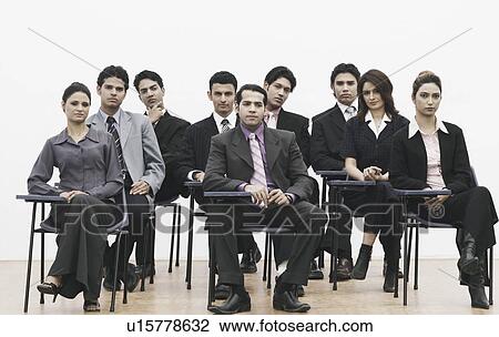 Stock Image - Group of business executives sitting on chairs. Fotosearch