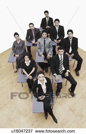 Stock Photo - High angle view of business executives sitting on chairs. Fotosearch