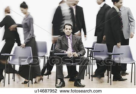 Portrait of a businessman sitting on a chair View Large Photo Image Stock Image - Portrait of a businessman sitting on a chair. Fotosearch