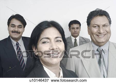 Stock Photo - Portrait of a businesswoman with three businessmen behind her. Fotosearch