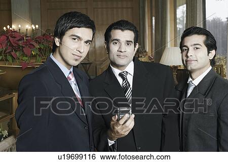 Portrait of three businessmen smiling View Large Photo Image Stock Photograph - Portrait of three businessmen smiling. Fotosearch