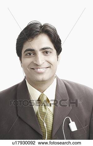Stock Image - Portrait of a businessman with an mp3 player in his pocket. Fotosearch