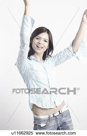 Portrait of a young woman listening to music dancing View Large Photo Image Stock Photography - Portrait of a young woman listening to music dancing. Fotosearch