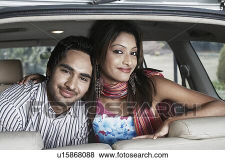 Close-up of a young couple sitting in a car View Large Photo Image Stock Photo - Close-up of a young couple sitting in a car. Fotosearch