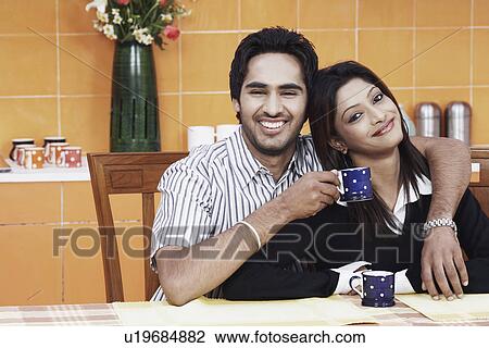 Stock Image - Close-up of a young couple smiling. Fotosearch